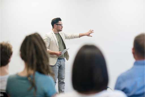 College instructor standing in front of a class.