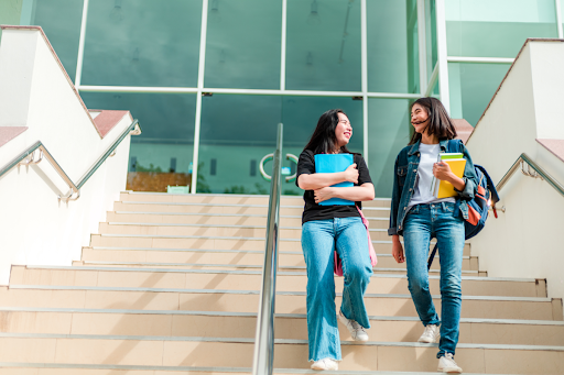 Two college students walking down a stairway