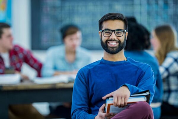 Smiling college student in class.