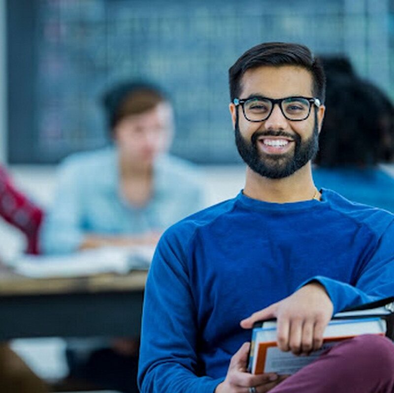 Smiling college student in class.