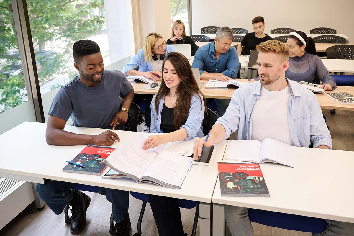 Students reading the CRM Marketing Automation textbook in the classroom