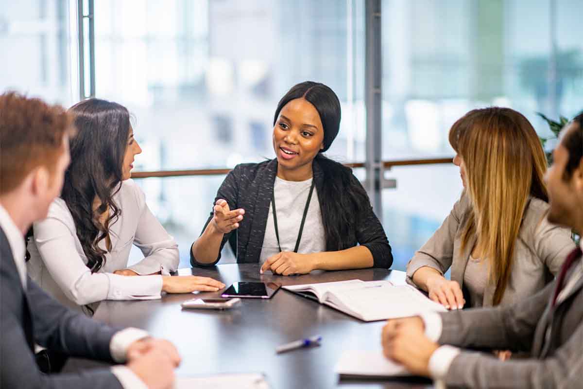 Confident sales executive speaking at a meeting with clients