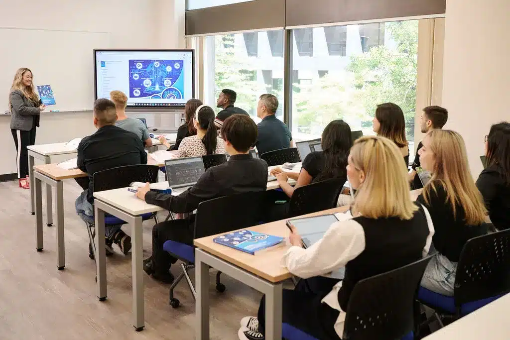 Educator teaching Mujo Learning Systems curriculum materials designed for teaching AI, business, and digital marketing in higher education